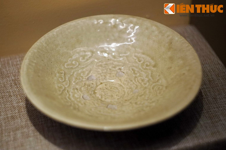 Đĩa gốm men ngọc trang trí hình vân mây. Gốm men ngọc là loại gốm được chế tạo công phu. Đất làm gốm được lọc kỹ tạp chất, xương gốm mịn, rắn chắc và nặng. Lớp men phủ ngoài rất dày, trong và bóng. Khi nung, men ngọc cần có độ lửa hoàn nguyên với thời gian vừa đủ, còn nếu không, các sắc độ men ngọc sẽ thay đổi.