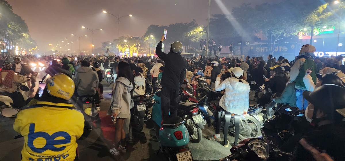 Việc đứng lên trên xe máy để xem và quay chụp những hình ảnh ấn tượng của màn pháo hoá dễ thấy tại khu vực Mỹ Đình.