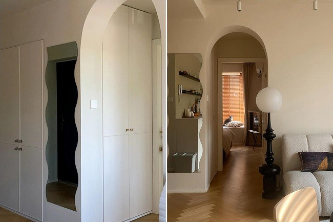 Lối vào phòng ngủ là phòng đựng đồ. Cửa mở cong tạo thêm sự mềm mại cho tổng thể.