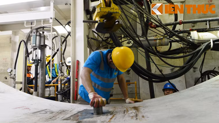 Các công nhân sẵn sàng dùng đinh vít hình cung để gắn kết các tấm vỏ với nhau. Mỗi tấm bê tông đều đúc sẵn lỗ vít gắn móc.