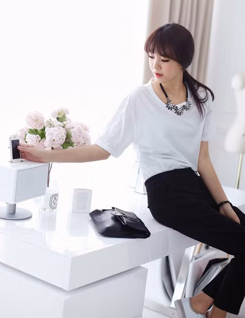 Áo thun cổ rộng thu gọn đôi vai.