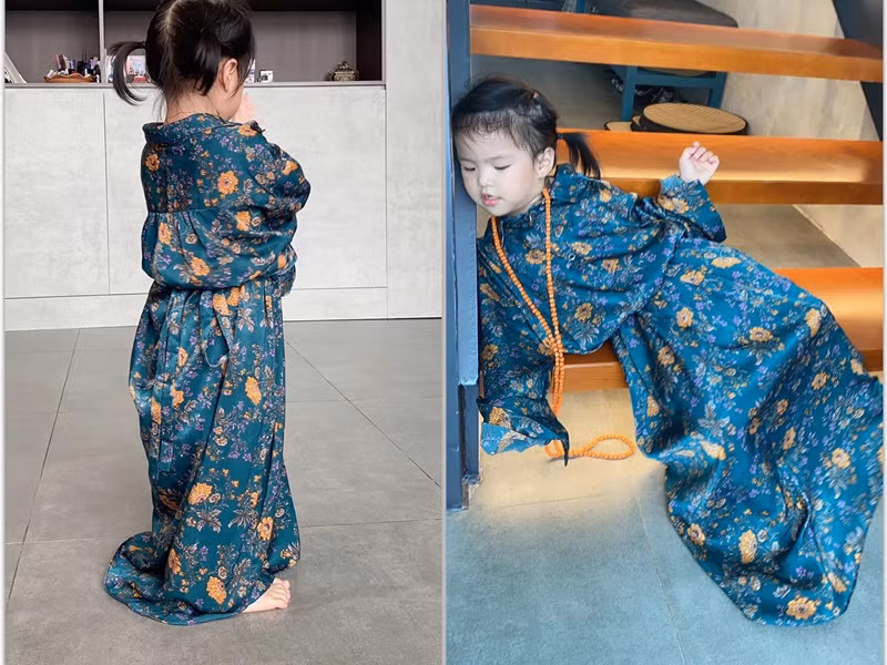 Bé Bông mặc áo của mẹ, tạo dáng "trầm tư" và "té xỉu".