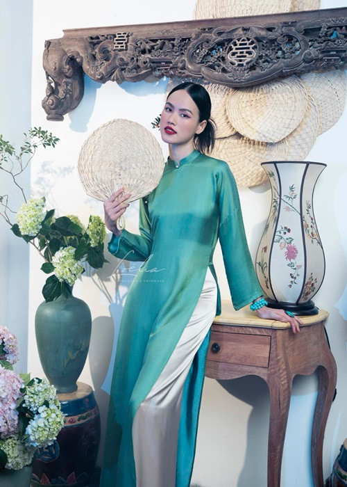 Tuyết Lan còn bung lụa với áo dài tông xanh.