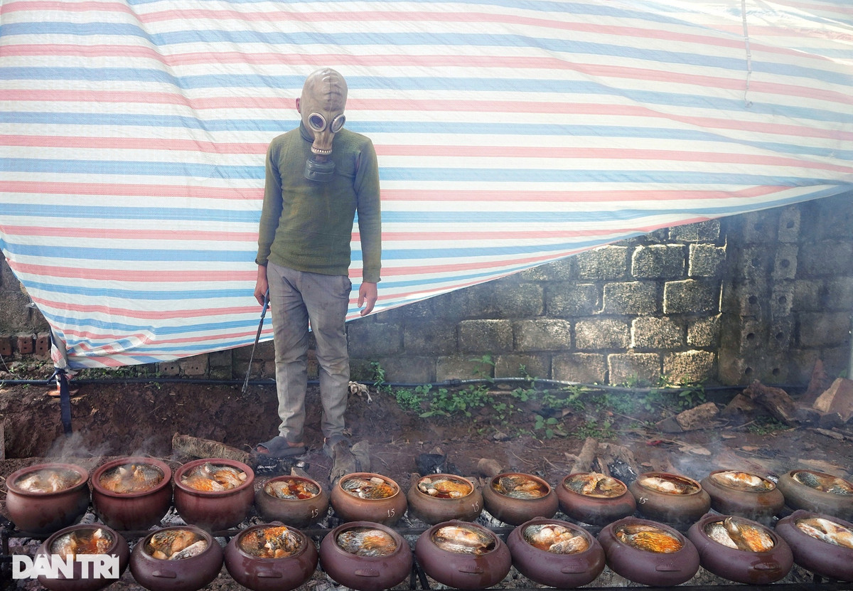 Để có thể làm hàng trăm niêu cá cùng một lúc, người dân tại đây nghĩ ra việc đeo mặt nạ phòng độc trong lúc kho cá, giúp hít thở thoải mái, không bị khói vào mắt và ảnh hưởng đến việc nêm nếm (Ảnh: Vân Hương).