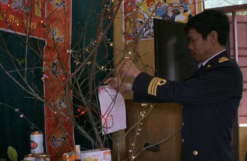 Thiếu tá Nguyễn Đức Nam, Trạm trưởng Trạm Radar 480 gắn thư chúc Tết của Bộ Tư lệnh Vùng 1 Hải quân lên cành đào hoa của trạm.