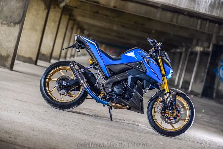 Toàn bộ dàn vỏ của chiếc Yamaha M-Slaz đã được tháo ra và sơn lại với màu xanh nhạt hơn so với sắc xanh GP truyền thống của Yamaha. Trong khi đó, một số chi tiết như ốp dưới đuôi, mỏ cày, khung, dè trước sơn 3D vân sợi carbon cực độc.