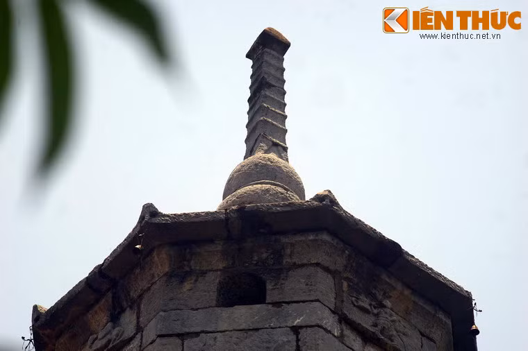 Đỉnh tháp chạm hình quả bầu hồ lô, phía trên là mô hình của một tòa tháp 9 tầng, tầng trên cùng có hình như búp sen, gợi liên tưởng đến một ngọn bút chĩa lên trời xanh.