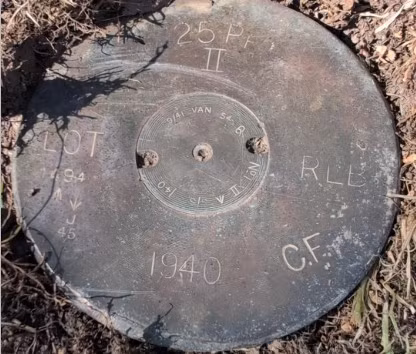 Trong lúc cắt cỏ ở sân sau, một người đàn ông ở Anh phát hiện vật thể lạ nhỏ nằm sâu 2,5cm dưới đất, khắc số "1940" và nhiều ký hiệu. (Ảnh: Express)