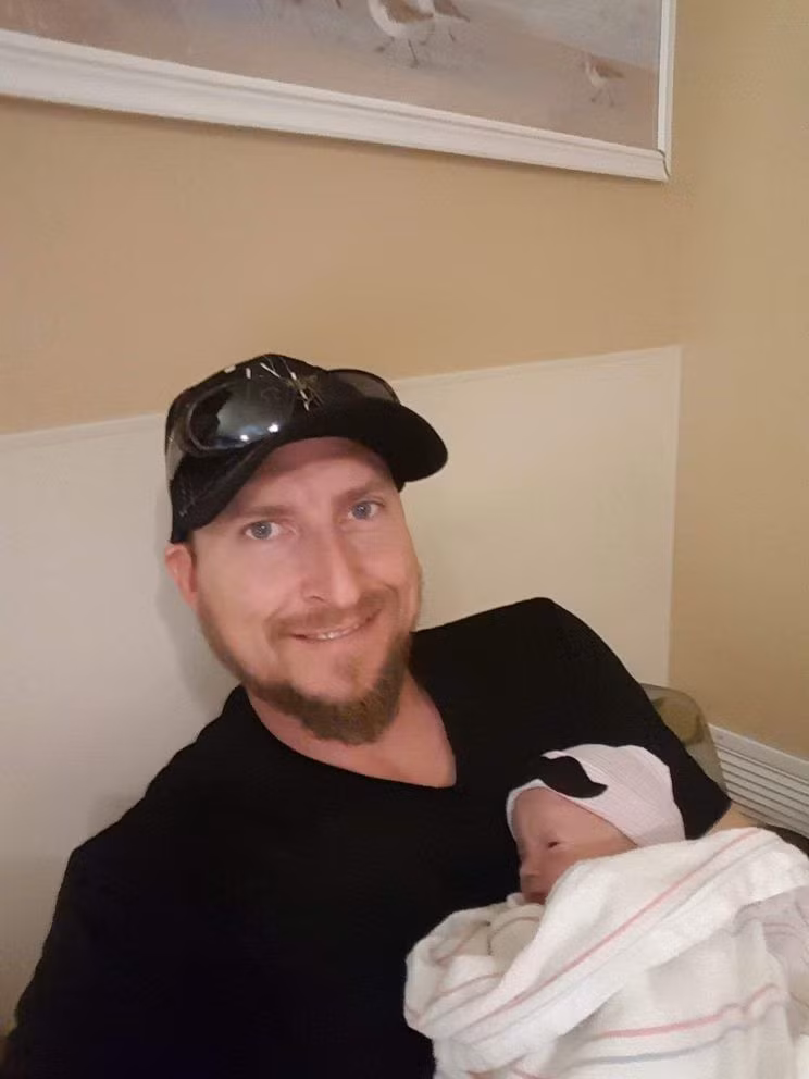 Hạnh phúc của người cha khi ôm 1 trong 2 bé song sinh vào lòng.