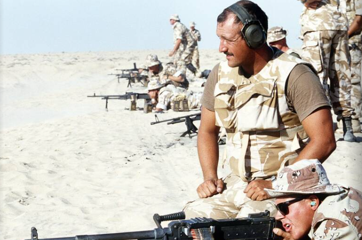 Một binh sĩ Anh đang theo dõi lính thủy đánh bộ Mỹ trong buổi huấn luyện vũ khí tại Abu Hydra Range trong Chiến dịch Lá chắn Sa mạc ngày 6/12/1990.