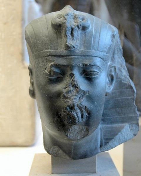 Trên đỉnh của tấm bia đá là hình khắc Mặt trời có cánh tượng trưng cho Thần Mặt trời Ra, biểu tượng của pharaoh Apries và 15 dòng chữ tượng hình bên dưới.