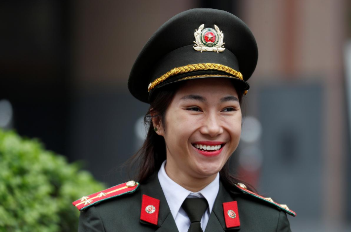 Nữ chiến sĩ làm nhiệm vụ bên ngoài khách sạn Melia ở Hà Nội hôm 24/2. Ảnh: Reuters.