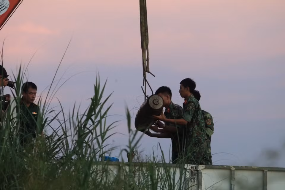 Lực lượng chức năng đưa được quả bom lên xe để di chuyển về nơi xử lý.