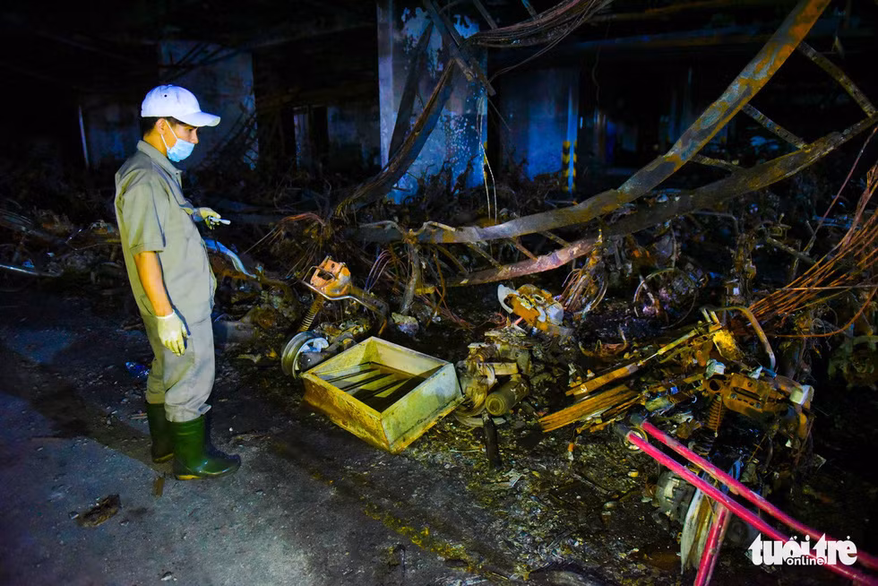 Nhân viên cứu hộ đi kiểm tra hầm xe, những xe bị thiêu trụi hoàn toàn được chủ đầu tư thông báo sẽ hỗ trợ một phần thiệt hại dựa trên giám định giấy tờ xe