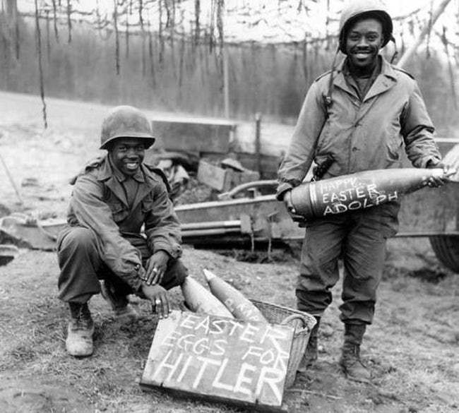 Lính da màu Mỹ và những quả đạn pháo với dòng chữ "trứng phục sinh dành tặng Hitler". Nguồn ảnh: Ranker.