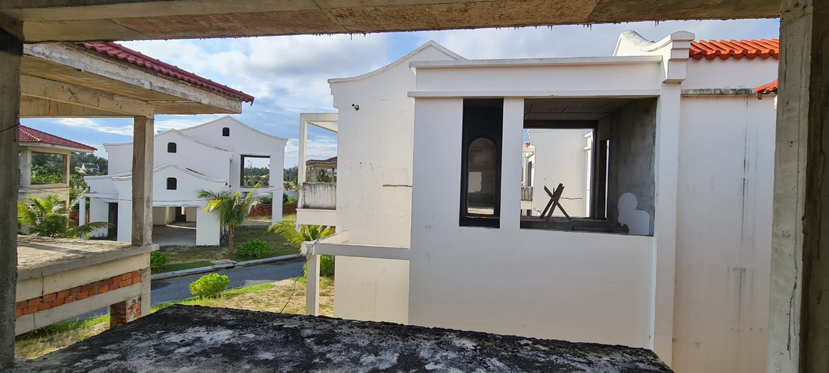 Rêu mốc phủ kín trên những hạng mục dang dở. Nhiều căn chỉ mới được đúc trụ và đổ sàn, còn chưa rõ hình hài. Diện tích mỗi căn nhà đã xây tường bao tại đây khá nhỏ, đúng kiểu "nhà ở phố cổ".