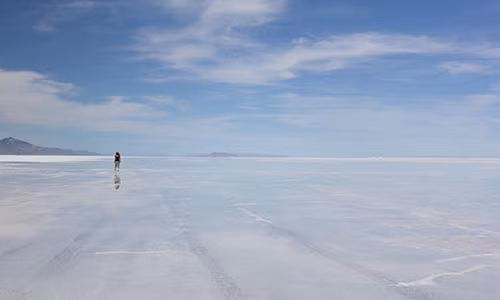 Con người nhỏ bé đứng giữa cánh đồng muối Benneville, bang Utah (Mỹ).