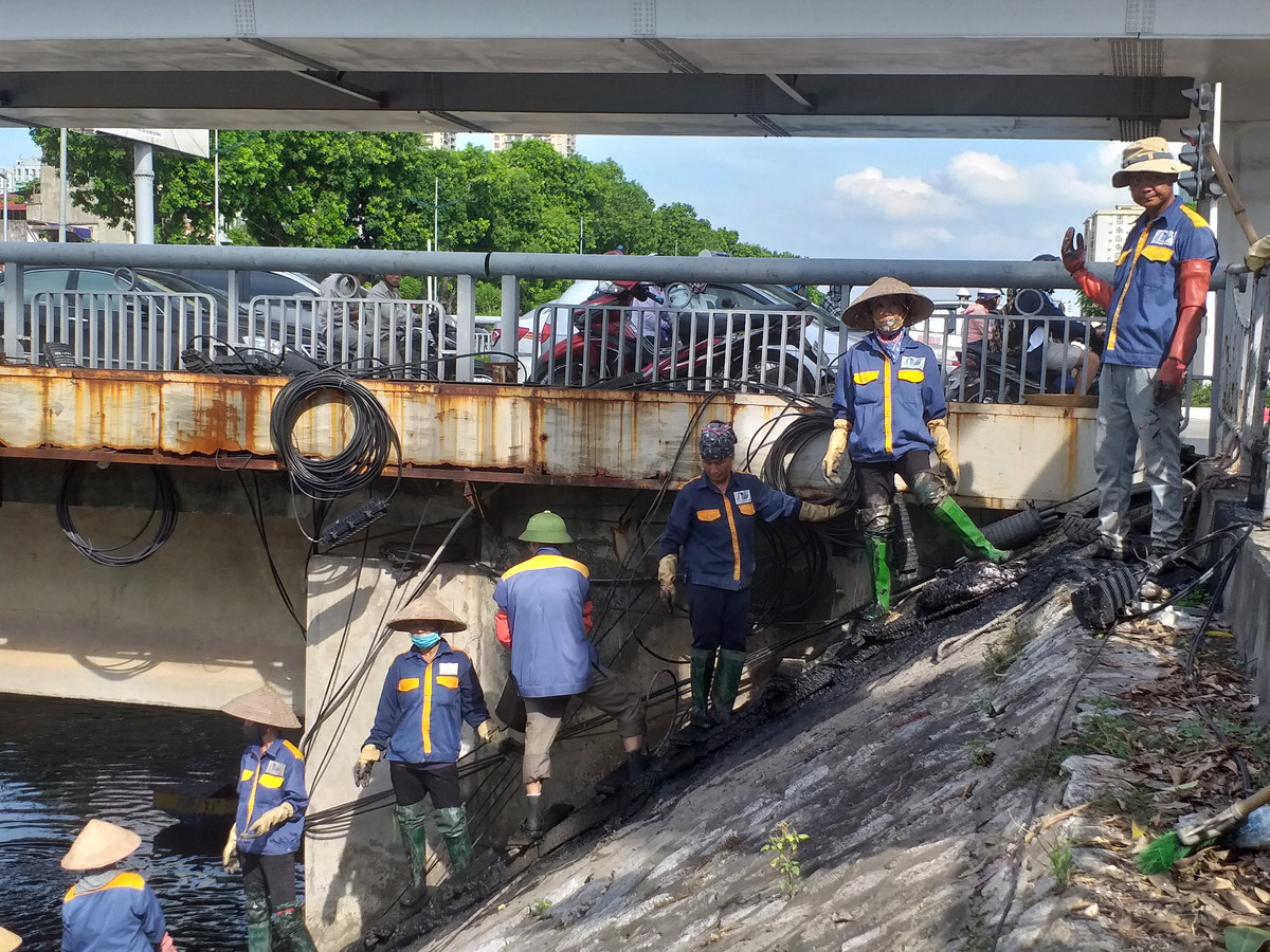 Dù lao động rất vất vả nhưng nhóm công nhân vẫn nở nụ cười trên môi khi người dân đi qua động viên, chào hỏi.