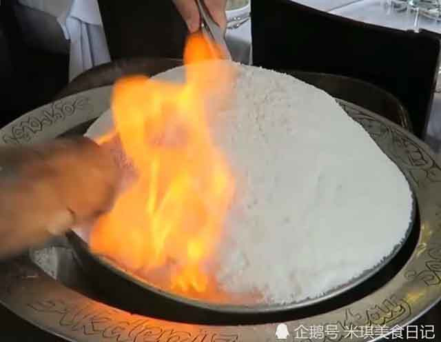 Ban đầu, người đầu bếp châm lửa đốt lên một tảng đá trắng đến mức cháy xém, rồi sau đó dùng búa đập vỡ, từng mảnh vụn rơi ra, dày như miếng gạch để lộ ra bên trong là một con gà được tẩm ướp đầy đủ gia vị và thảo dược.