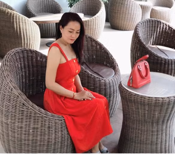 Chị diện váy đỏ hai dây sành điệu phối với túi xách cùng tông. Ảnh: FBNV.