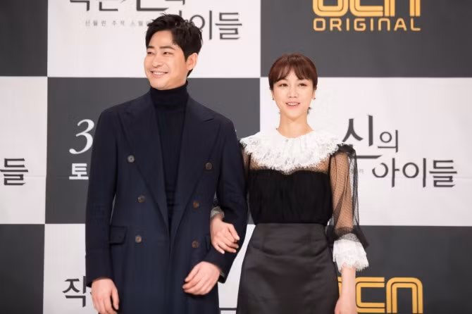 Nam diễn viên thường phối áo len cổ cao với áo choàng dài đầy nam tính.