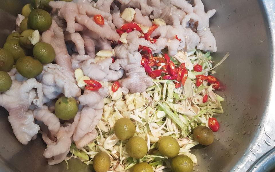 Chân gà sấu mắm chua ngọt có thể coi là phiên bản cập nhật mùa hè của món chân gà sả tắc nức tiếng. Sấu vào mùa dày mình, gọt rửa sạch, ngâm cho thật ngấm thứ mắm chua ngọt thơm thơm mằn mặn. Đi kèm thứ chân gà lai rai "chấm mút" thần thánh, cực hợp để "gặm nhấm" xem phim những ngày mưa.