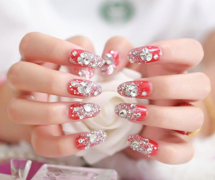 Những mẫu móng đính đá sắc đỏ rực rỡ thế này được nhiều chị em khá ưa chuộng để diện chơi Tết.