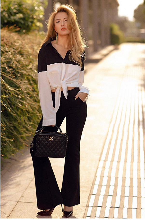 Trang phục và phụ kiện trắng đen được Hoàng Thùy Linh phối một cách hài hòa, khéo khoe eo thon sau Tết.