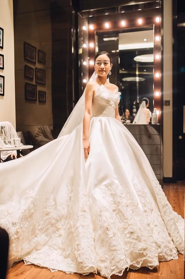 Khi làm lễ, Phí Linh diện chiếc váy cưới bồng bềnh như công chúa với gam màu trắng tinh khôi, điểm xuyết hoa văn tinh xảo của NTK Gia Nguyễn.