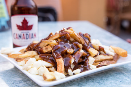 12. Poutine – Canada: Poutine được chế biến từ khoai tây chiên với “topping” là nước sốt thịt thơm lừng cùng pho mát cheddar beo béo. Dân bản xứ tin rằng món ăn này có khả năng hấp thụ chất cồn rất tốt. Ảnh: Internet.