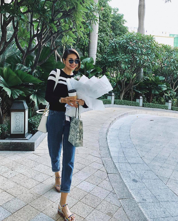 Siêu mẫu Thanh Hằng trông rất phong cách với quần jeans ống côn, áo sweater phối cùng sandal đế xuồng.