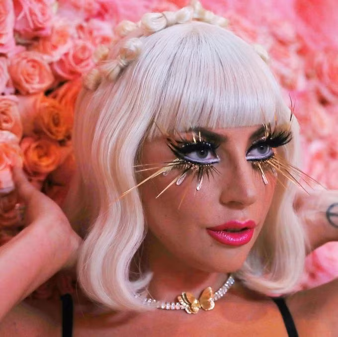 Không làm mọi người thất vọng, Lady Gaga gây ấn tượng với kiểu trang điểm quái dị lẫn độc đáo, điểm nhấn là hàng lông mi giả dài ngoằng làm từ những mảnh vàng lá được gắn theo dáng mắt mèo.