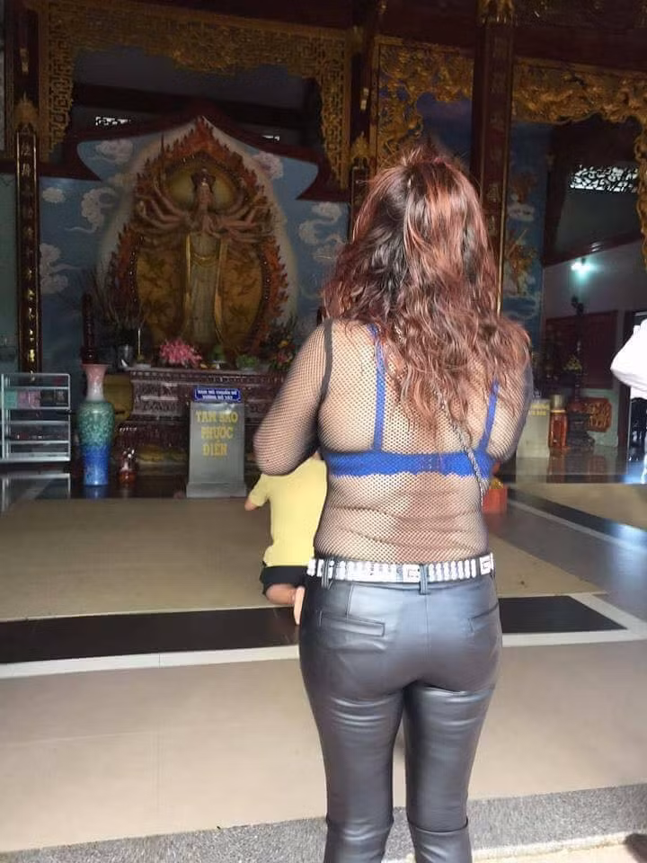 Người phụ nữ đi lễ chùa mặc trang phục nhức mắt mặc như không khiến nhiều người sốc. Ảnh: Vietnammoi.