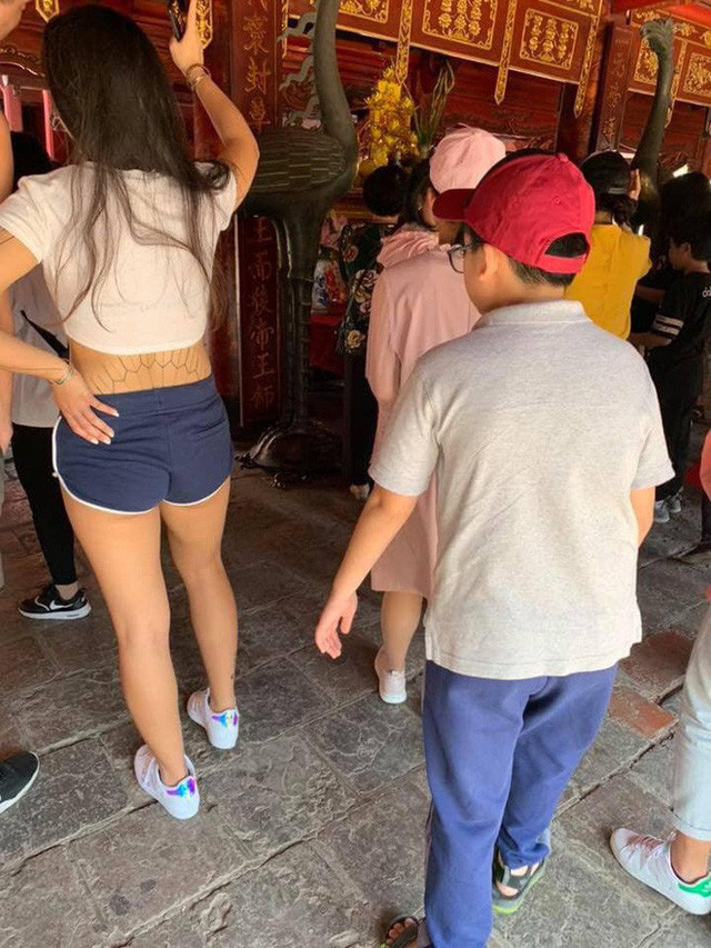 Những ngày đầu năm, dư luận xôn xao với bức hình chụp một cô gái trong trang phục hớ hênh như đi "tập gym" vào lễ chùa được chia sẻ. Ảnh: Facebook.