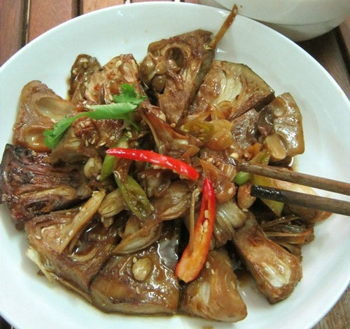 Cho dầu ăn lên chảo đun nóng, thêm hành tím phi thơm, cho từng lát mít vào chảo và chiên đều 2 mặt. Thấy mít đã sém mặt, đổ phần sốt ướp mít vào chảo, thêm nửa chén nước lọc rồi đậy nắp, kho mít ở lửa nhỏ. Cắt thêm 2 trái ớt vào nồi để mít có vị cay cay ngon hơn. Đun nhỏ lửa trong khoảng 10 - 20 phút. Nếu thấy nước trong nồi hơi cạn thì bạn cho thêm ít nước lọc. Mít chín, bạn cho ra đĩa, rắc thêm tiêu, ngò rí và mè rang cho thơm.