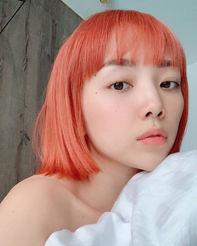 Tóc Tiên để tóc mái ngang và nhuộm màu cam sáng, giúp tôn lên các đường nét hài hòa trên gương mặt.