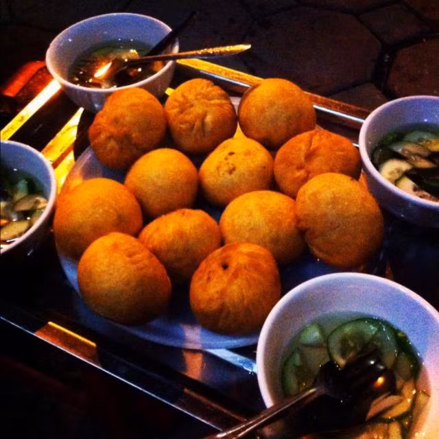 Bánh bao chiên tại 18 Lương Văn Can và 122B C5 Tô Hiệu: đây là 2 trong số những địa điểm có bánh bao chiên ngon nhất tại Hà Nội. Bánh cũng có nhân thịt, mộc nhĩ, nấm hương… thường được chấm kèm với nước mắm chua ngọt và dưa góp ăn rất ngon mà không hề bị ngấy. Ảnh: Monngonhanoi. 