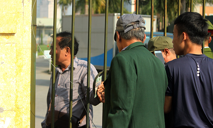 Một số người phía ngoài đưa tiền vào cho người bên trong đi vào bên trong trụ sở VFF để mua vé nhưng không được.