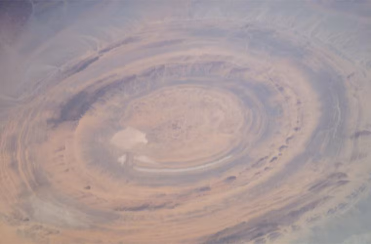 “Richat Structure” (Cấu trúc Richat) hay còn gọi là “Eye of the Sahara” (Con mắt của Sahara) là một kết cấu địa chất khổng lồ bao gồm nhiều vòng elip lồng vào nhau. Nằm ở trung tâm phía Tây nước Mauritania, gần khu vực Ouadane, vòng tròn có đường kính 50 km này có thể nhìn thấy từ không gian.