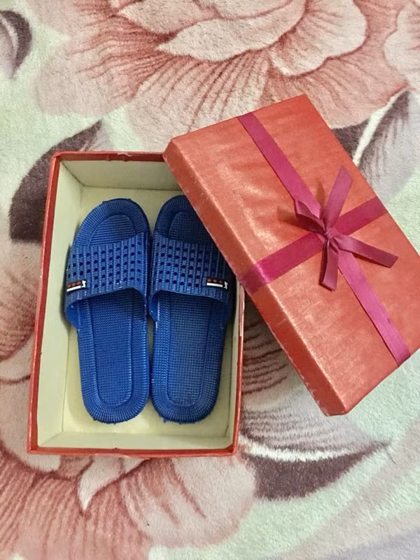 Đôi dép được đóng hộp cẩn thận khiến người vợ thích thú. Ảnh: Quốc Vương.