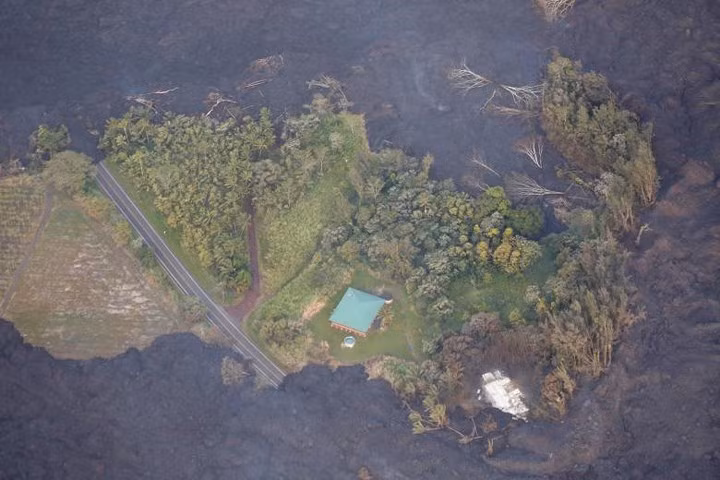 Nhìn từ trên cao, có thể thấy rõ một mảng xanh tươi sắp bị mảng đen của dung nham nuốt trọn.