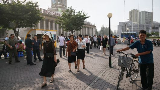Mọi người đi qua một quảng trường công cộng bên ngoài ga đường sắt trung tâm ở Bình Nhưỡng vào ngày 12/6.