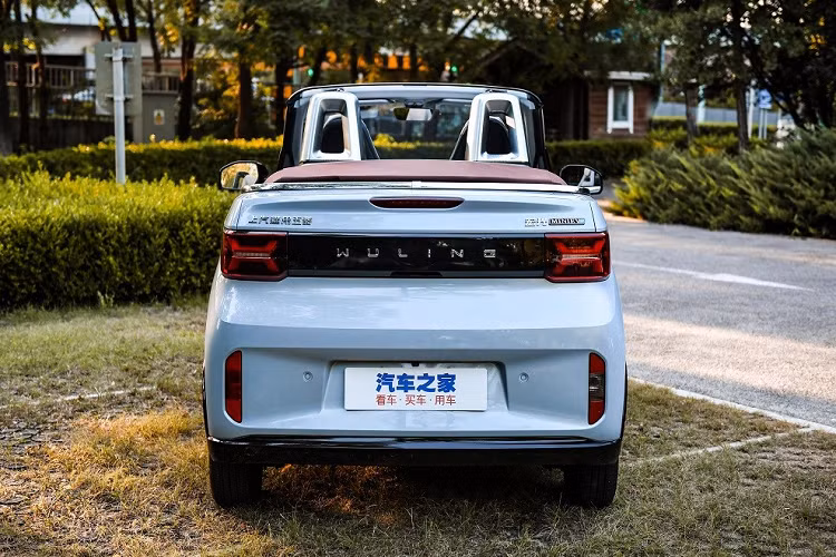 Nối liền với logo màu bạc của thương hiệu Wuling là 2 nẹp mạ crôm mới. Ngay cả cản trước của mẫu xe mui trần này cũng khác biệt so với Wuling Hongguang Mini EV. Vòng sang bên sườn, chúng ta có thể bắt gặp ốp la-zăng với 6 chấu màu bạc, cột A sơn màu xám nhám và mui nỉ màu đỏ rượu hoặc đen. Mui nỉ của xe có thể mở ra trong thời gian chỉ 6 giây.