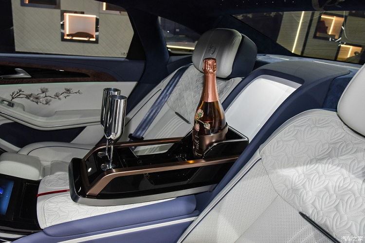 Đằng sau là 2 ghế thương gia với khoảng duỗi chân rộng rãi. 2 ghế này được tách riêng bằng bệ tì tay trung tâm khá lớn, tích hợp màn hình trung tâm để hành khách chỉnh các tính năng của xe. Trước mặt hành khách là 2 màn hình giải trí nằm trên lưng ghế trước. Bên cạnh đó là ngăn chứa chai champagne và 2 chiếc ly ở giữa hàng ghế sau để hành khách thưởng thức trên đường đi.