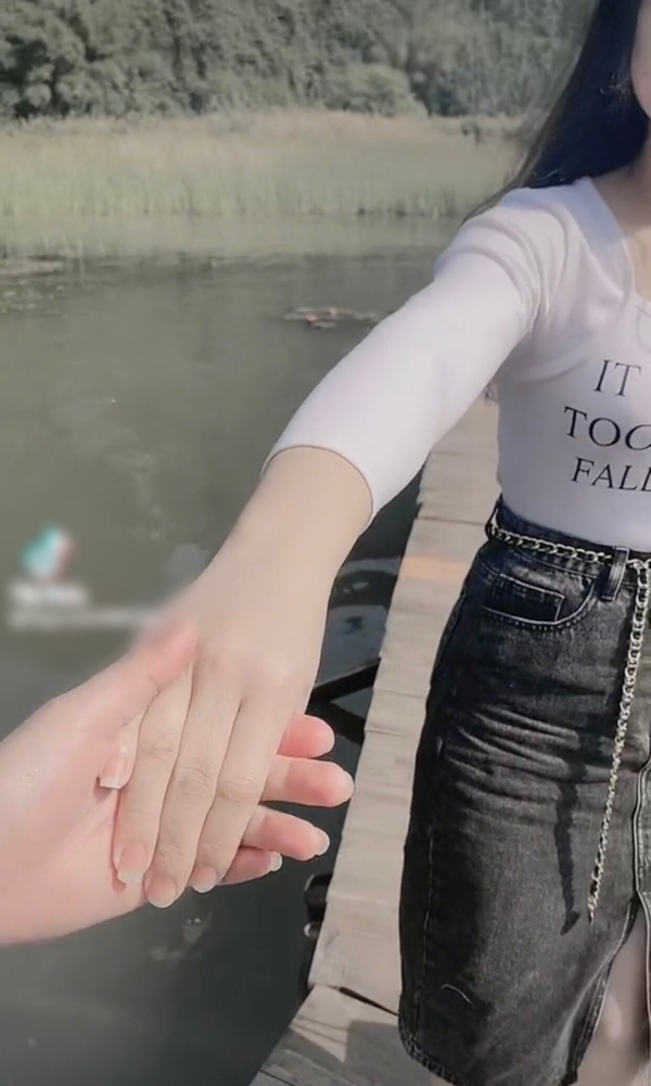 Mở đầu đoạn video theo trào lưu TikTok, cô gái cũng nắm tay chàng trai của mình rồi dần dần buông ra và chạy lùi về phía sau như những video khác.
