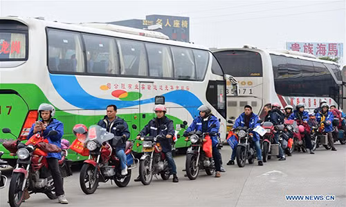 Những người lao động nhập cư xếp hàng dài chờ đổ xăng miễn phí để về quê hôm 18/1.