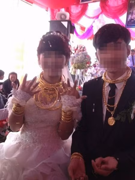 Một bức ảnh cưới của cặp đôi tại Hà Tĩnh cũng từng gây "bão" dư luận. Không chỉ chịu chơi dùng siêu xe đón dâu, mâm cỗ sơn hào hải vị, cô dâu chú rể còn khoác lên người vòng, kiềng, nhẫn vàng lóa mắt.