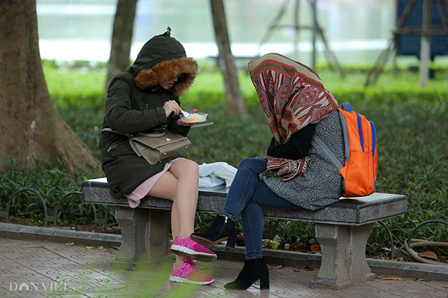 Hai du khách quấn kín khăn tại phố đi bộ Hà Nội. Do ảnh hưởng của không khí lạnh kết hợp hội tụ trong đới gió Tây trên cao nên Thủ đô và nhiều nơi khác có mưa, khiến cái lạnh càng kinh khủng.