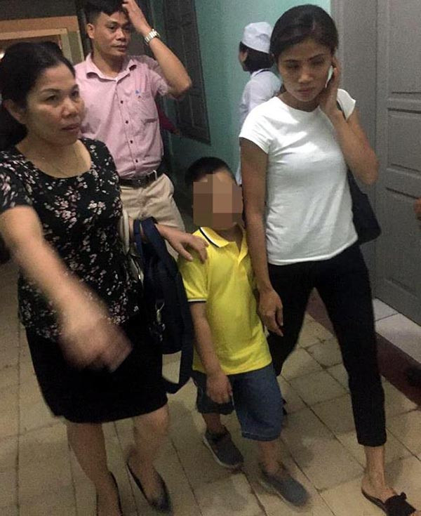 Cháu Đoàn N.M, cùng chị Hương đi đến bệnh viện.