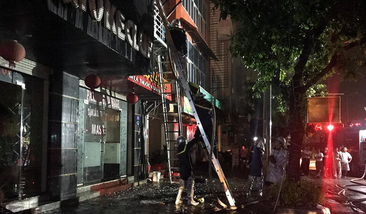 Lực lượng Cảnh sát PCCC sử dụng thang để tiếp cận tầng trên của quán massage.